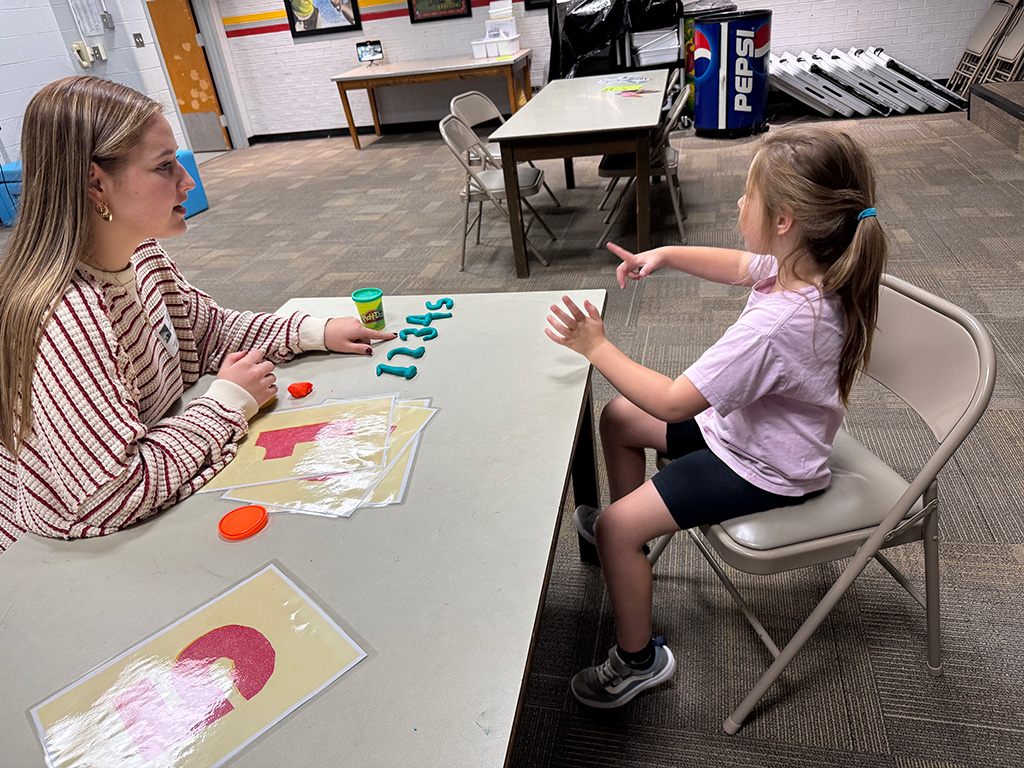 Educator with kid at RCOE Mathematics Clinics